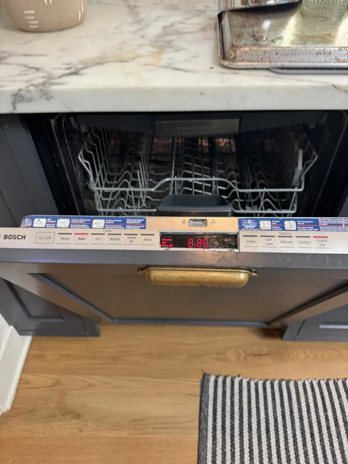 A Bosch dishwasher with the door open during service
