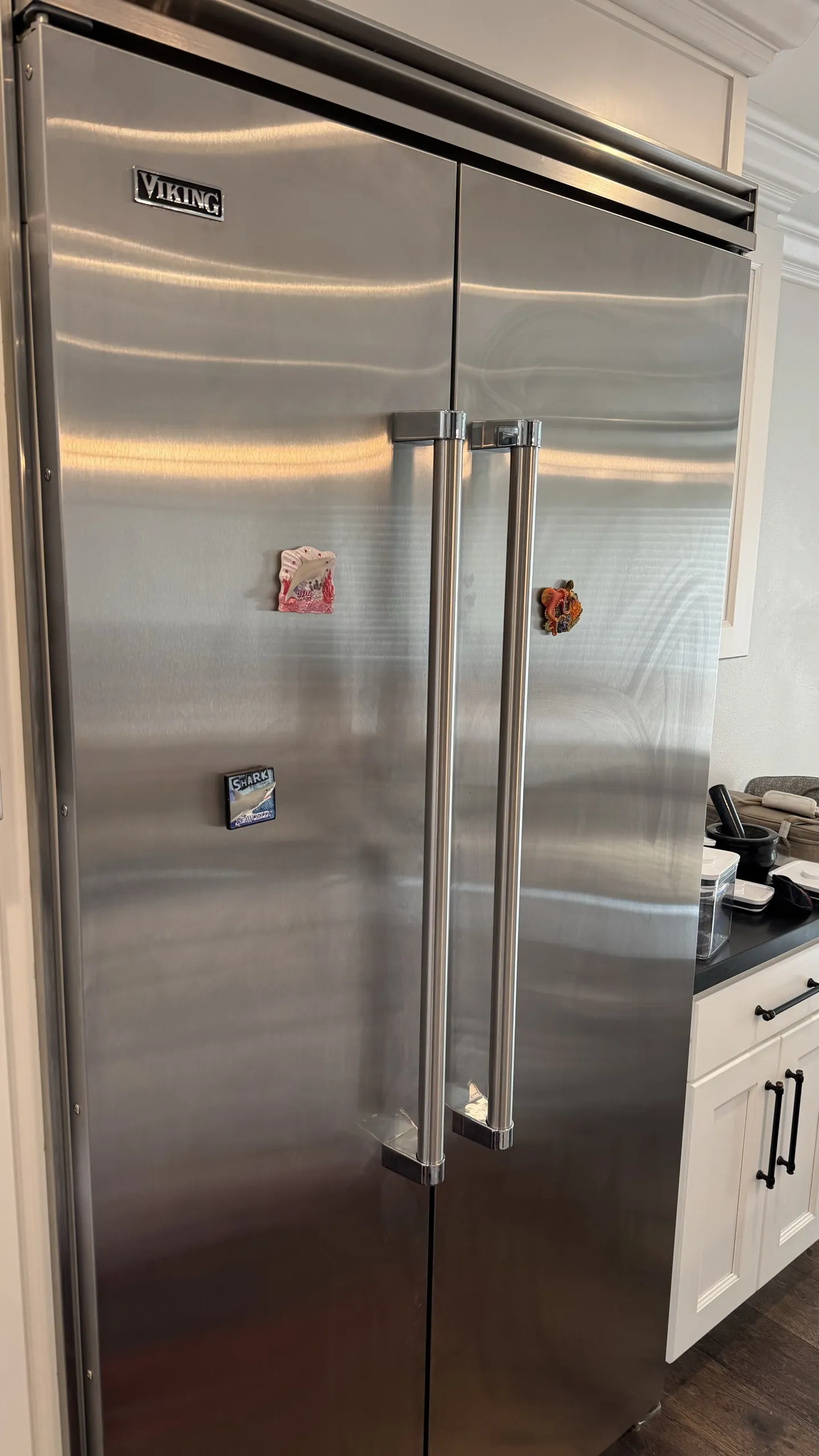 A built-in stainless refrigerator on a service call
