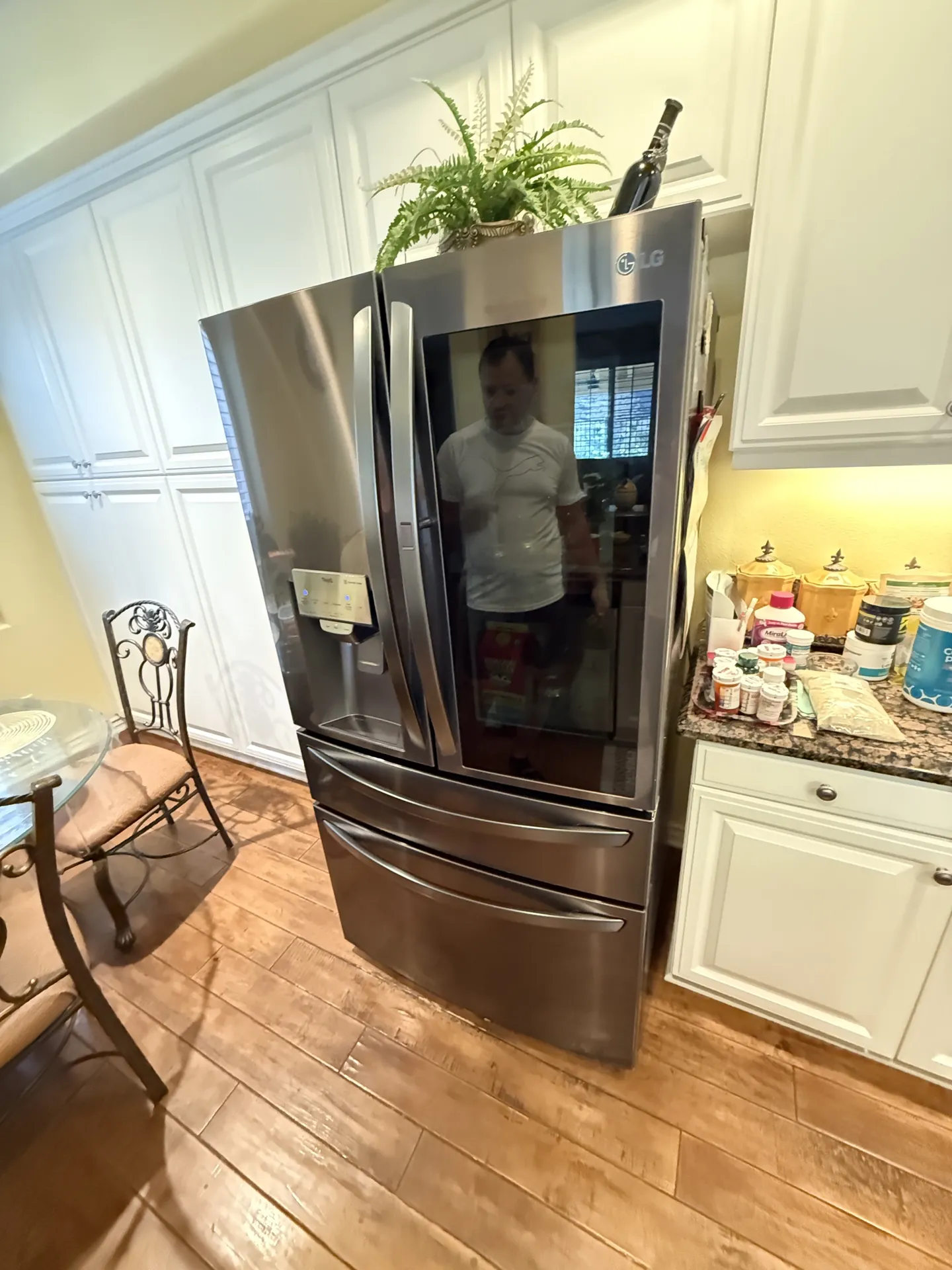 A French-door refrigerator in a white kitchen after the repair