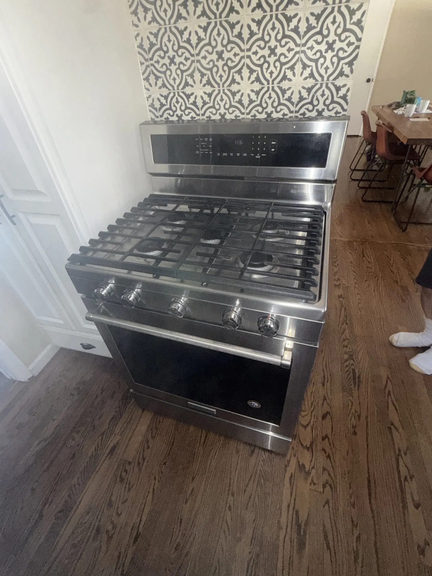A KitchenAid range with a tile backsplash