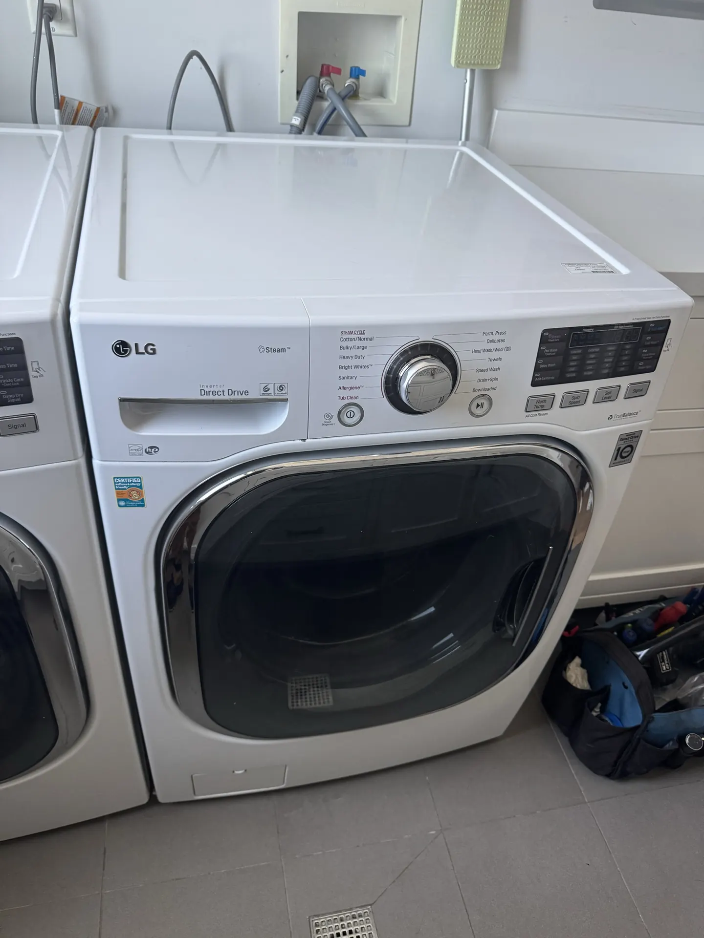 An LG washer and dryer pair in a garage laundry