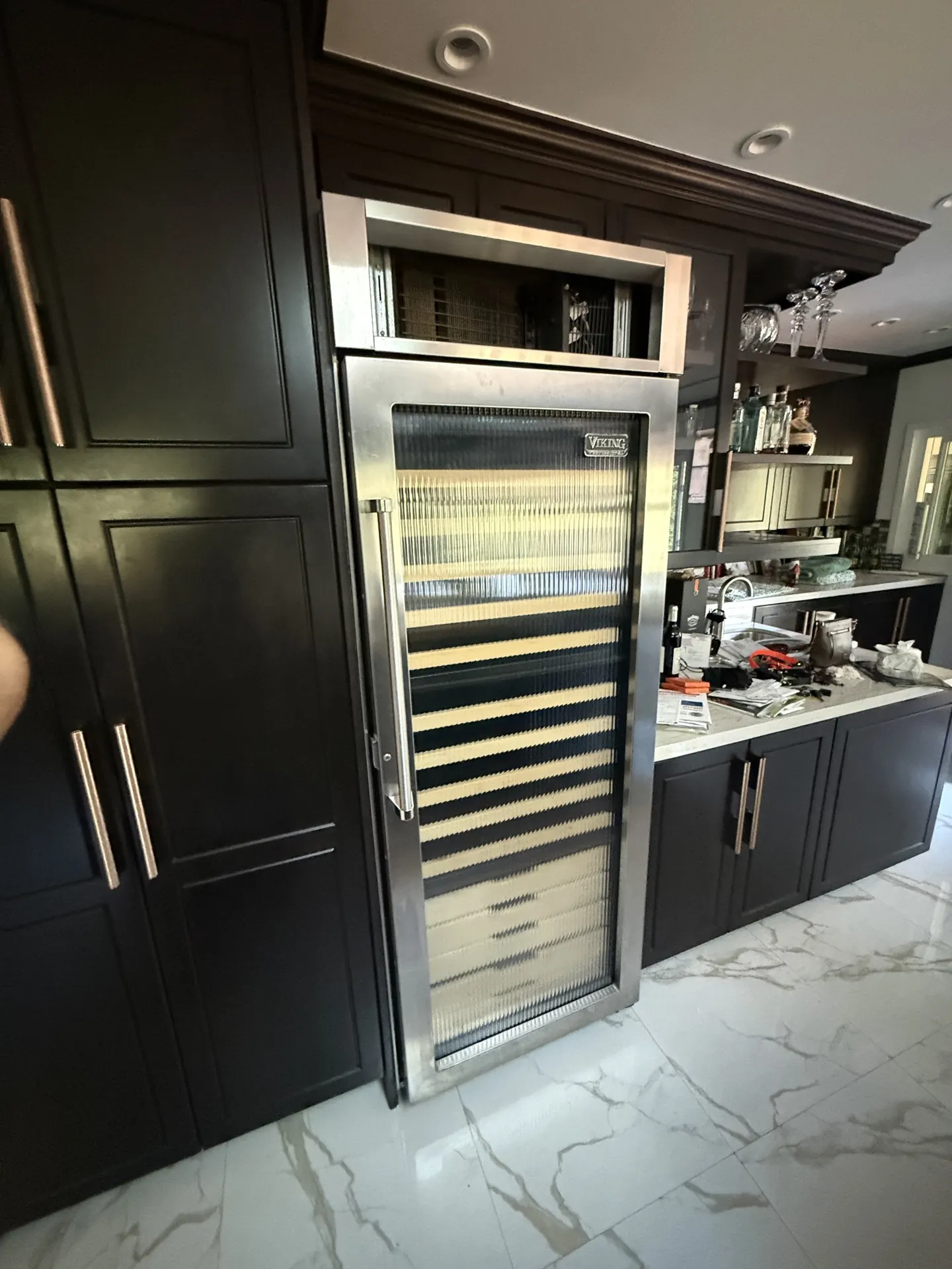 A Viking wine cooler built into dark cabinetry